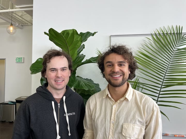 A picture of Daniel Filan and Avery Griffin standing and smiling at the camera.S